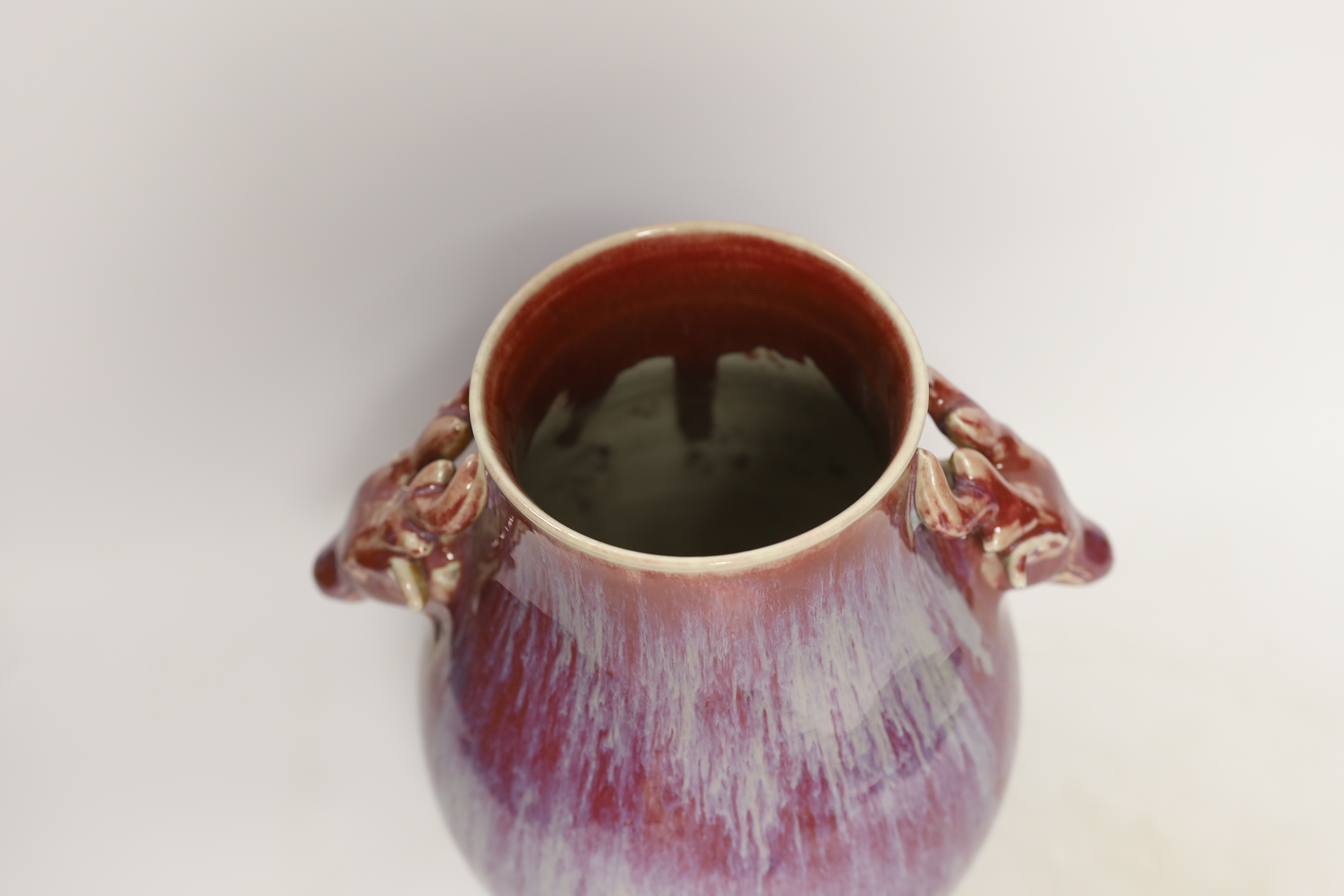 A Chinese sang de boeuf vase, stag head handles, 26cm